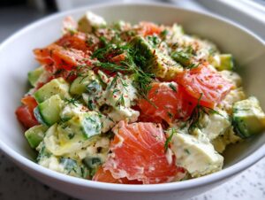 Close-up of a vibrant cottage cheese smoked salmon salad with chunks of avocado and cucumber, garnished with dill and paprika.