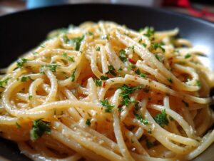 Close-up of a bowl of Creamy Lemon Pasta, garnished with fresh parsley and red chili flakes.