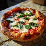 A close-up of a freshly baked Margherita pizza with melted mozzarella, rich tomato sauce, and fresh basil leaves.