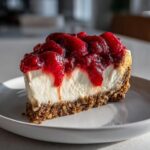 A slice of Cherry Pecan Cheesecake Lush on a plate, with a rich cherry topping and pecan crust.