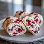 Close-up of delicious cranberry tortilla roll ups filled with cream cheese and herbs.