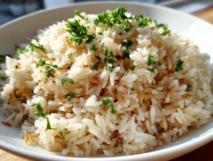 Close-up of a fluffy mound of homemade rice pilaf recipe garnished with fresh parsley and toasted bits.