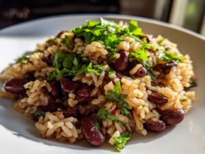 A close-up of a serving of flavorful black beans and rice topped with fresh green cilantro.