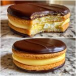Close-up of two delicious boston cream pie cookies, one with a bite taken out showing vanilla cream filling.