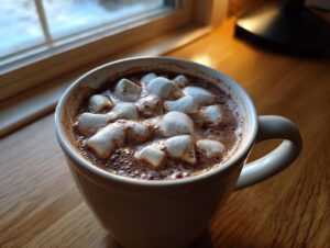 Close-up of a white mug filled with rich hot chocolate topped with melting marshmallows, perfect for a crockpot hot chocolate recipe.