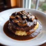 A rich, juicy Salisbury steak topped with mushroom gravy and served over creamy polenta.